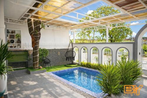a pool in the middle of a house with a ceiling at BY Home in Hue