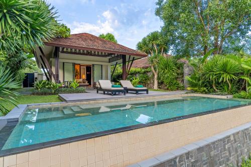 a swimming pool in front of a villa at Banyan Tree Lang Co in Hue