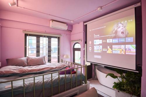a room with a bed and a large screen at Trên Mây HST - 181 Trần Phú in Hanoi