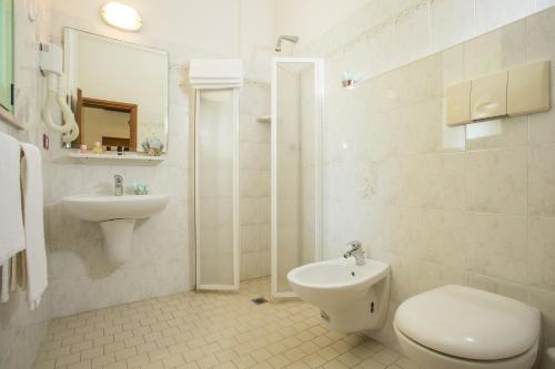 a white bathroom with a toilet and a sink at Hotel Dover Rooms & Coffee Adults Friendly in Cervia