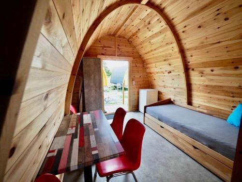 a room with a table and chairs and a bed at Camping Willam in Reichenau