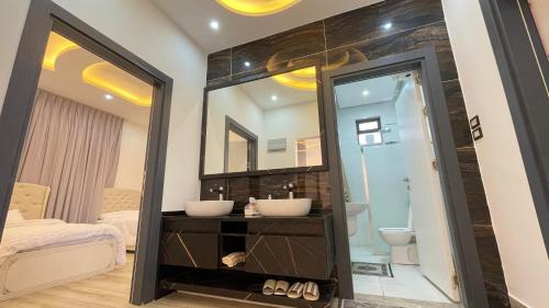 a bathroom with a sink and a mirror at Villa W2 in Amman