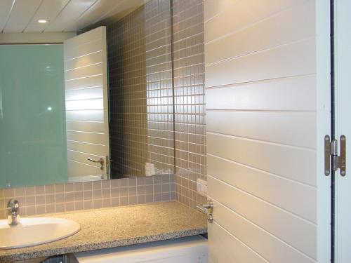 a bathroom with a sink and a mirror at Apartamentos Rodamar in L'Estartit