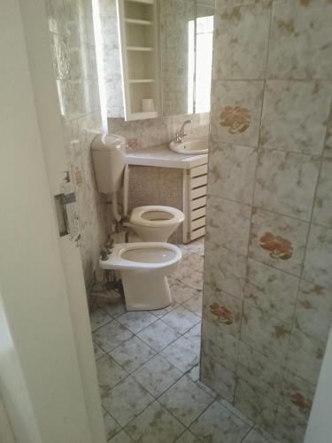 a bathroom with a toilet and a sink at Matte Guest House in Potchefstroom