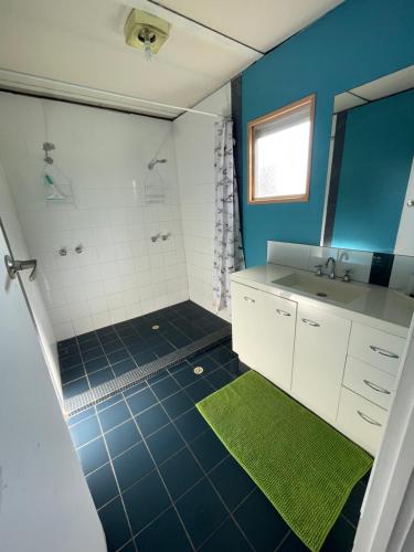 a bathroom with a sink and a shower at Cervantes Beach Shack in Cervantes