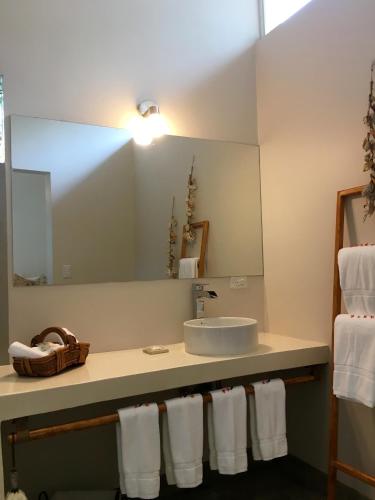a bathroom with a sink and a mirror at La Ramona Charming Hotel in Tamarindo