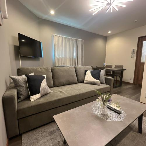 a living room with a couch and a table at 2, Nerima, 1st floor apartment, 練馬 in Tokyo