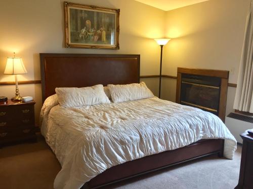 a bedroom with a bed and a fire place at Afton House Inn in Afton