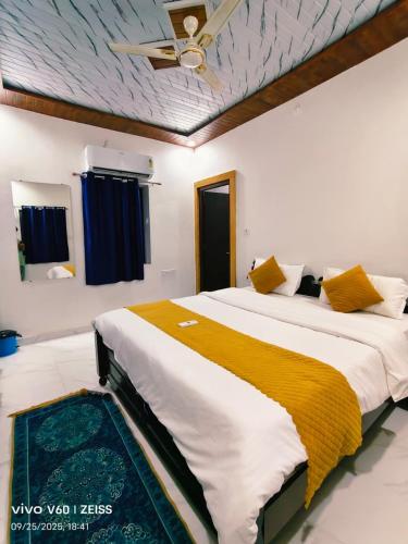 a bedroom with a large bed with a ceiling at Hanu Guest house in Jaisalmer