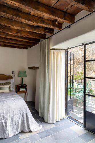 a bedroom with a bed and a sliding glass door at Number One Bruton in Bruton