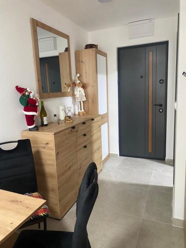 a room with a wooden dresser and a mirror at ChiaraKop in Kopaonik