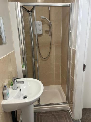 a bathroom with a shower and a sink and a shower at Comfy private studio Moseley in Birmingham