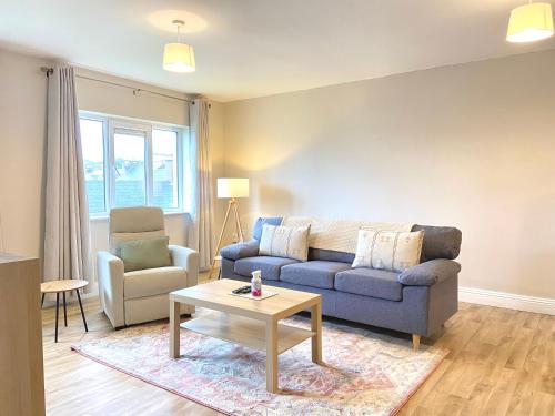 a living room with a couch and a table at Anchors Rest, Cobh in Cobh