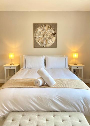 a bedroom with a white bed with two side tables at Anchors Rest, Cobh in Cobh