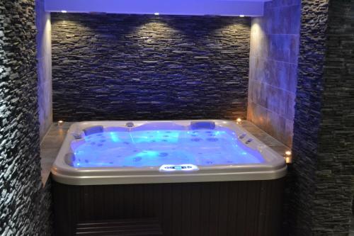 a jacuzzi tub in a stone wall with lights at Wellness hotel Sauna in Malá Morávka