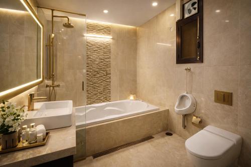 a bathroom with a tub and a toilet and a sink at Hotel Prime Stay in Noida