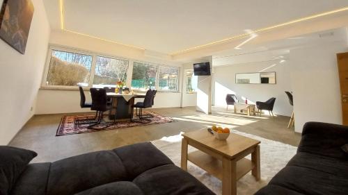 a living room with a couch and a table at Luxus Terrassenappartement Berg & See 2 in Bodensdorf