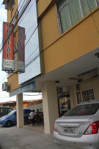 a car parked in front of a building at Hostal Rosa Mar in Manta