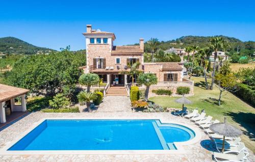an estate with a swimming pool in front of a house at Can Palleta Nou in S'Horta
