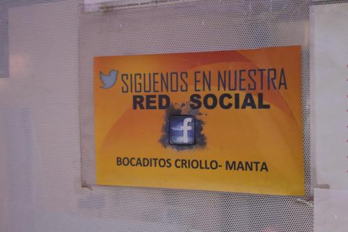 a sign on a window with a sign on it at Hostal Rosa Mar in Manta