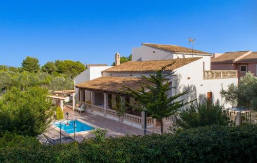 a house with a swimming pool in front of it at Pomeres Nou in Sa Coma