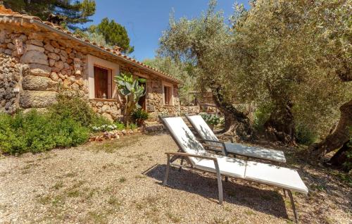 a white bench sitting in front of a building at Rustica Es Seguers in Fornalutx