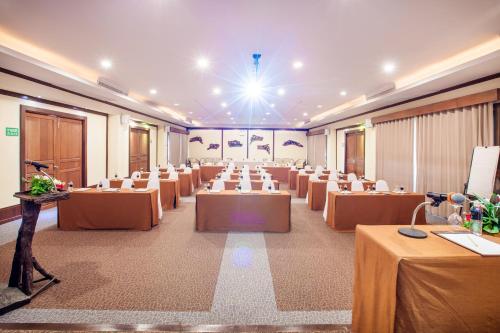 a large room with tables and chairs in it at Sibsan Resort & Spa Maetaeng Chiang Mai in Mae Taeng