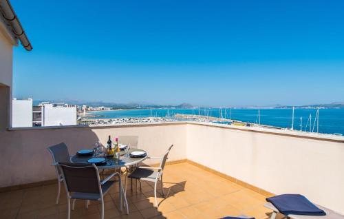 a table and chairs on a balcony with a view of the ocean at Minimal in Can Picafort