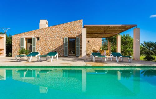 a villa with a swimming pool in front of a house at Pedra Viva in Son Servera