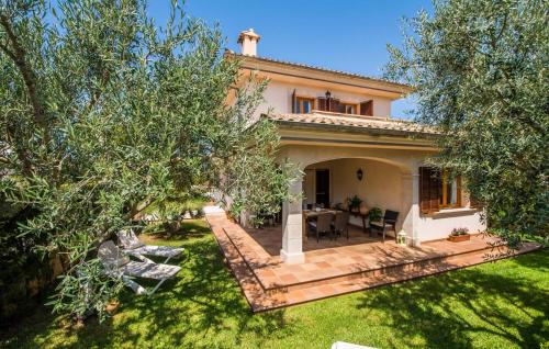 a house with a patio and a yard with trees at Calma De Son Serra De Marina in Son Serra de Marina