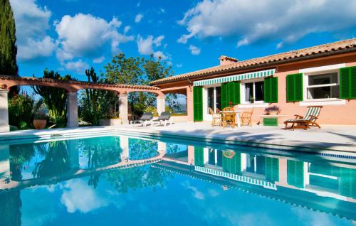 a villa with a swimming pool and a house at Santa Maria in Artá