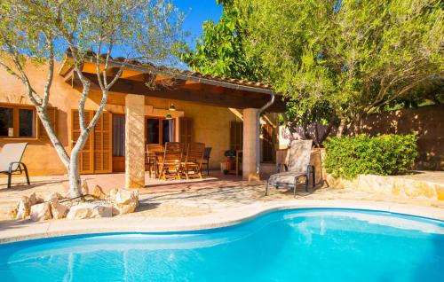 a swimming pool in front of a house at Sa Plana in Cala Bona