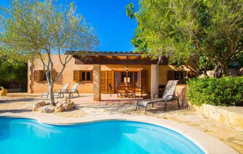a swimming pool in front of a house at Sa Plana in Cala Bona