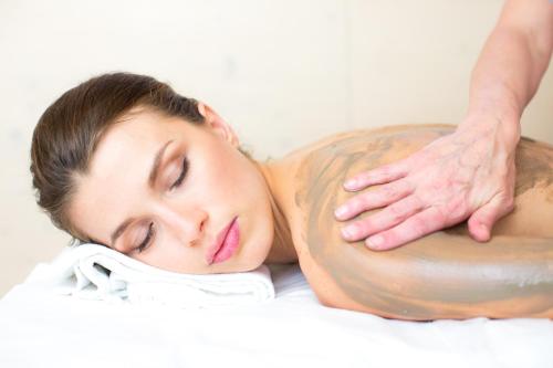a woman getting a back massage on a bed at Villa Abbondanzi Resort in Faenza