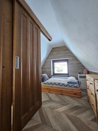 a small bedroom with a bed in the attic at JIROTOVY BOUDY II in Telnice