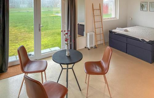 a room with chairs and a table and a bed at Beach Front Home In Samsø With House Sea View in Kolby Kås