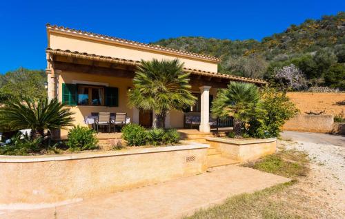 a house with palm trees in front of it at Can Safiro in Son Servera