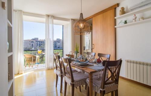 a dining room with a table and chairs and a balcony at Mirella in Pollença