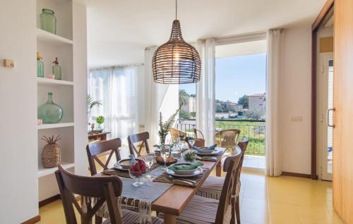 a dining room with a table and chairs and a large window at Mirella in Pollença
