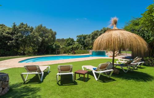 a group of chairs and an umbrella next to a pool at Son Favar in Capdepera