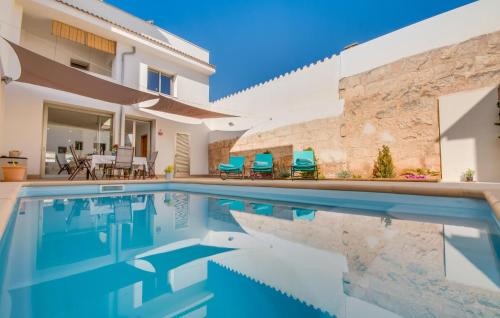 a villa with a swimming pool and a house at Foners Mallorquins in Muro