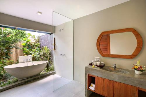 a bathroom with a sink and a mirror at Sativa Villas Ubud with Private Pool in Ubud