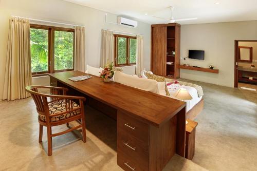 a living room with a desk and a couch at Sativa Villas Ubud with Private Pool in Ubud