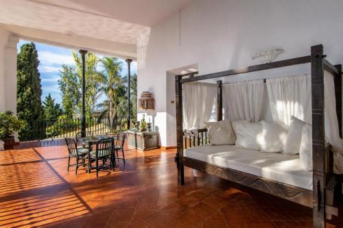 a bedroom with a bed and a balcony with a table at Catalunya Casas Impressive and Idyllic mansion for up to 40 people! in Banyeres del Penedes