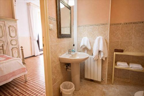 a bathroom with a sink and a bed and a mirror at Catalunya Casas Impressive and Idyllic mansion for up to 40 people! in Banyeres del Penedes