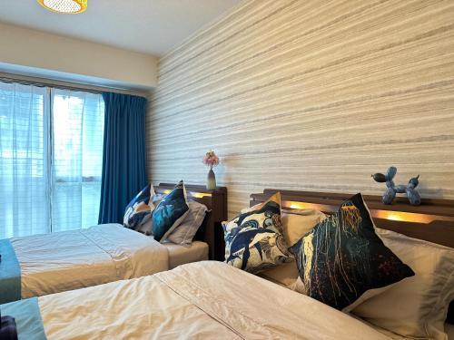 a bedroom with two beds and a window at nestay apartment tokyo shinjuku in Tokyo