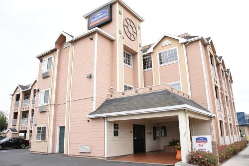 a large building with a clock on top of it at Howard Johnson by Wyndham Salinas in Salinas