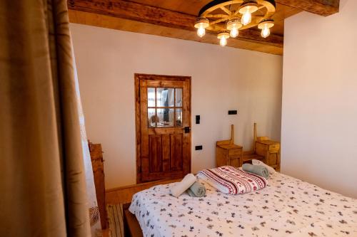 a bedroom with a bed and a window at The Forest Nest in Dealu Armanului