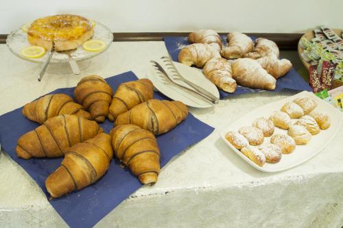 a table topped with lots of croissants and other pastries at Hotel La Tripergola in Pozzuoli