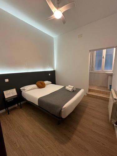 a bedroom with a bed and a ceiling fan at Center Madrid habitaciones in Madrid